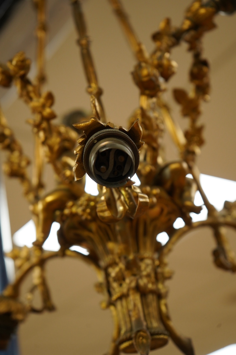 A gilt metal chandelier in the form of a cherub in a basket, 65cm high. Condition - fair, untested